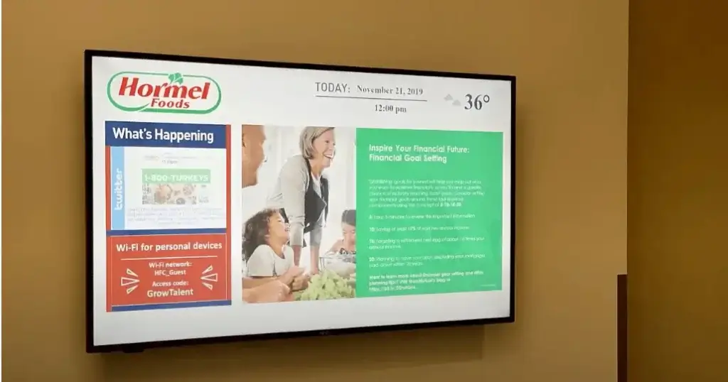 Hormel Food digital signage bulletin board featured in breakroom, displaying twitter social posts and internal announcements.