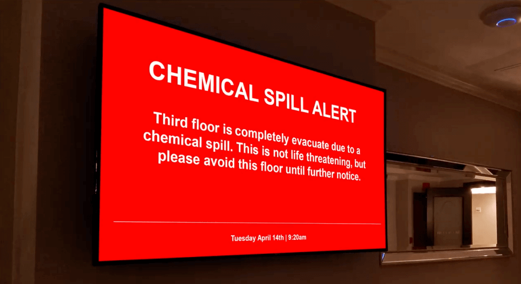 A chemical spill alert on a digital bulletin board screen