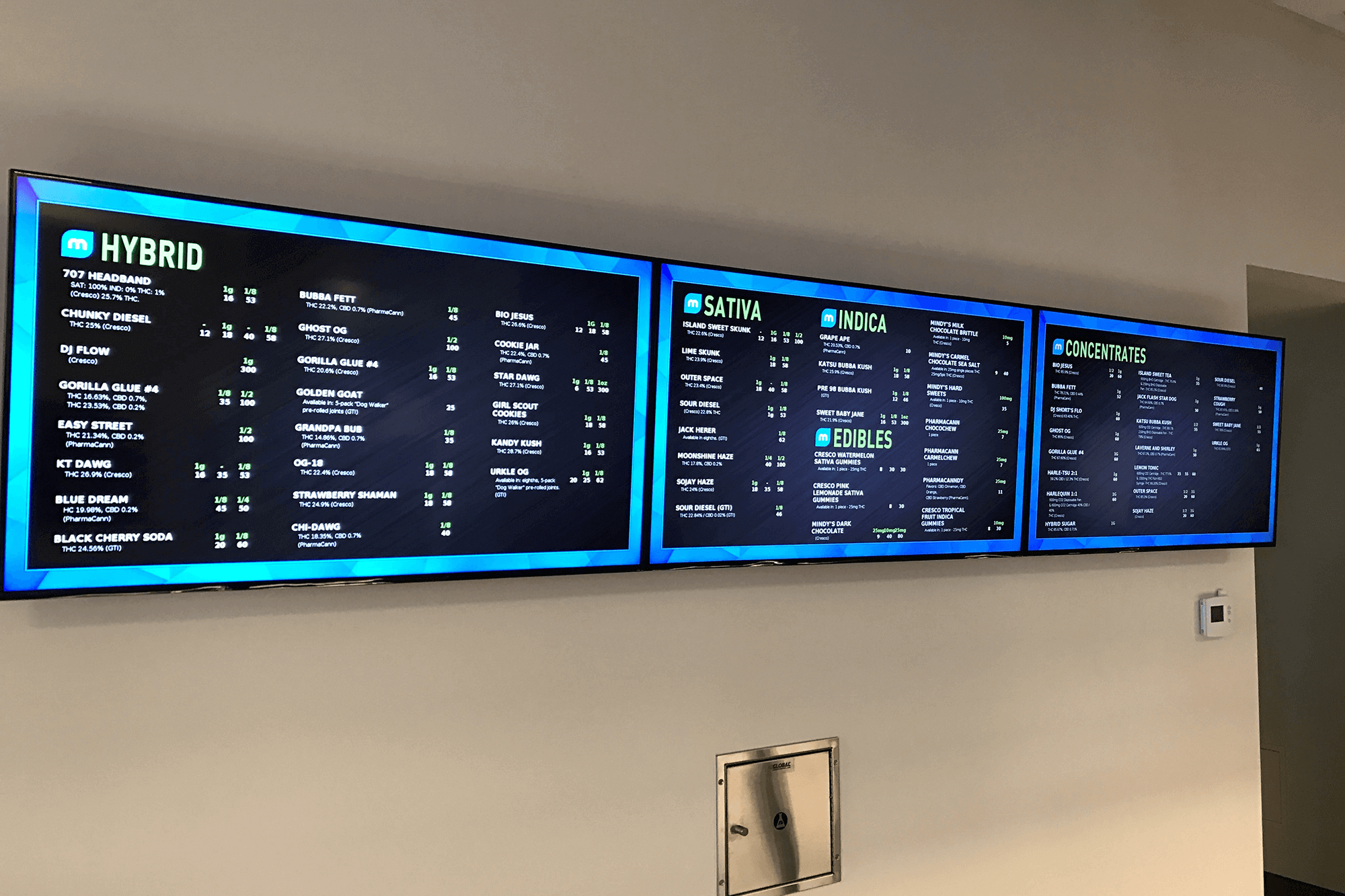 Multiple blue and black menu board digital signage displaying multiple menu items