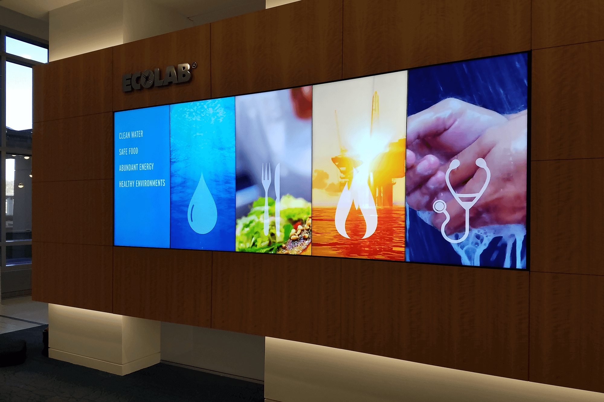 Colorful digital video wall being displayed at the Ecolab office