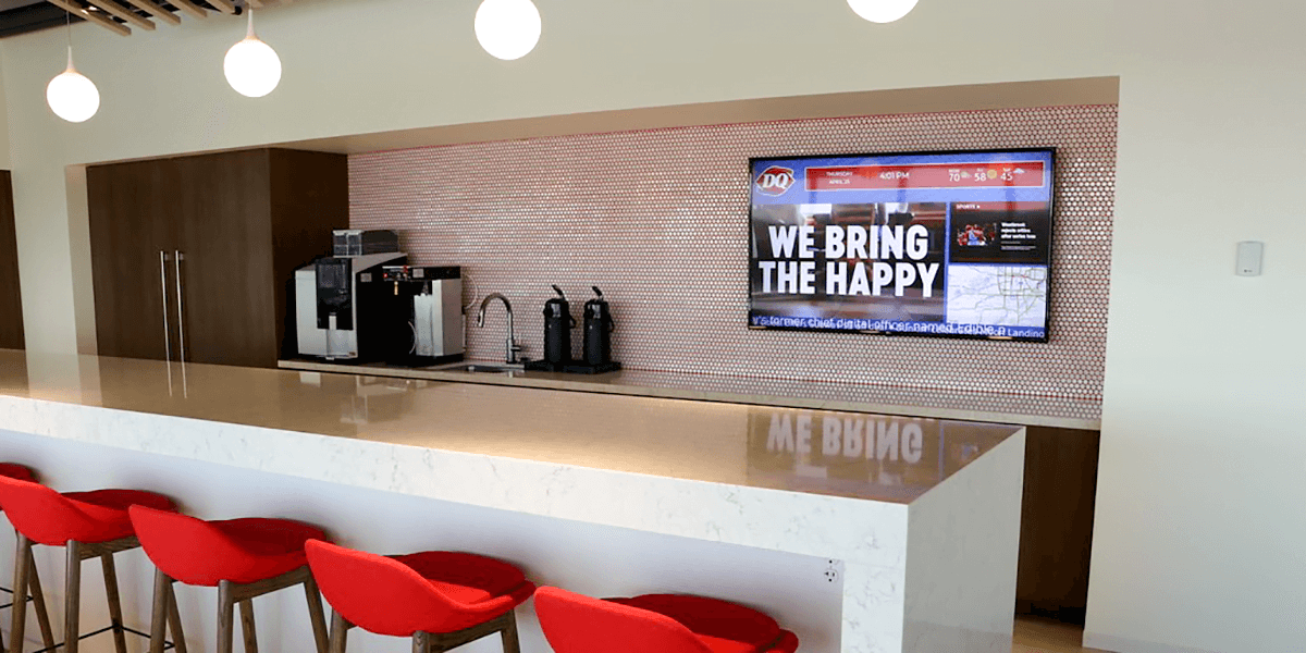 Customer example of a red and blue breakroom digital signage featuring local map and weather, social feed, and positive messaging 