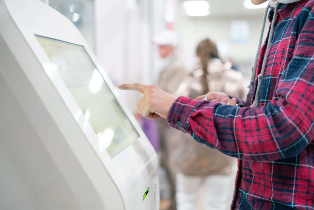 close up person using touch screen panel in post office to recieve a package f