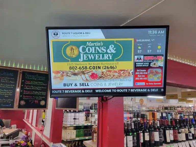Pathfinder Attractions Route 7 Liquor Deli retail digital signage from Reach Media Network displaying jeweler advertisement and deli promotion.