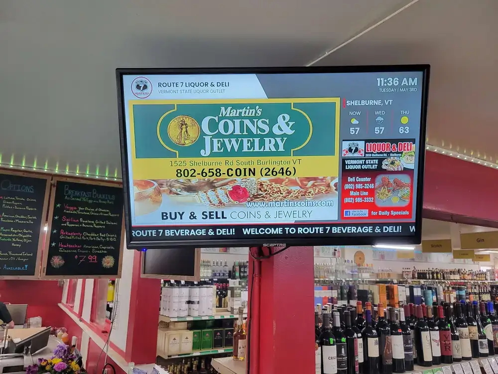 Pathfinder Attractions Route 7 Liquor Deli retail digital signage from Reach Media Network displaying jeweler advertisement and deli promotion.