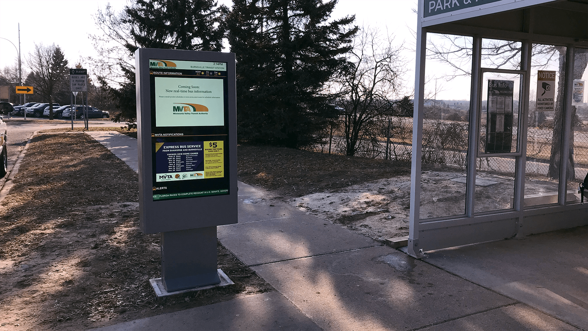 Outdoor digital signage displayed by a bus stop