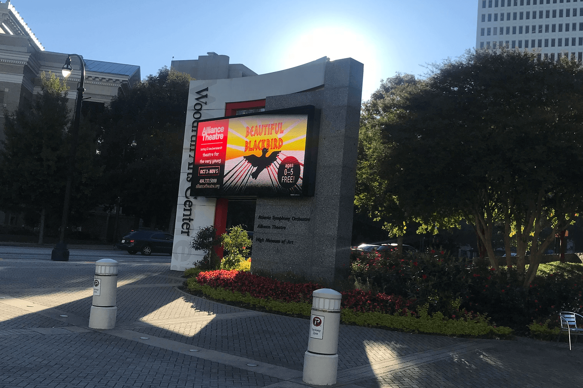 Red and black outdoor digital signage featured in front of an Arts Center