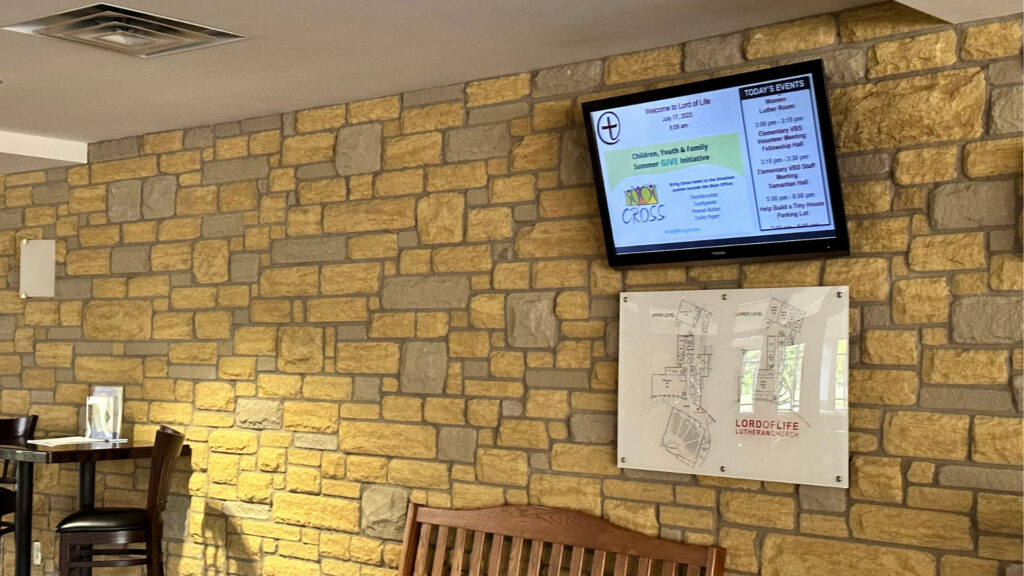 Churches-min Church digital signage featured in lobby, above building map.