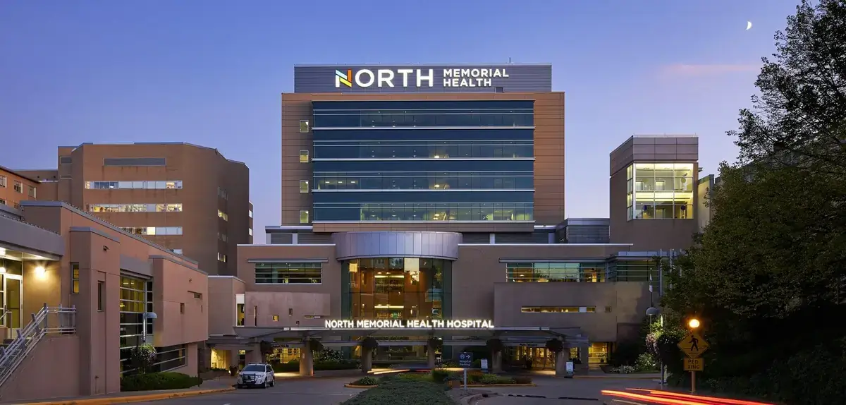 North Memorial Health hospital exterior entrance at dusk, Reach Media Network digital signage case study
