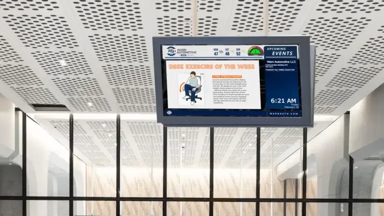 Warn Automotive manufacturing digital signage example from Reach Media Network displaying digital announcements, scrolling calendar, and weather