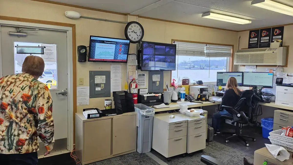 Steel Dynamics case study, office digital signage display from Reach Media Network showing transportation info, calendar events, and news ticker