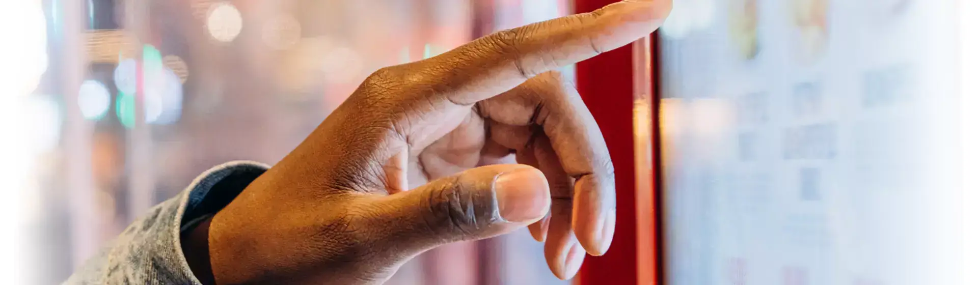 finger interacting with a touchscreen, Reach Media Network Guide to Enterprise Digital Signage