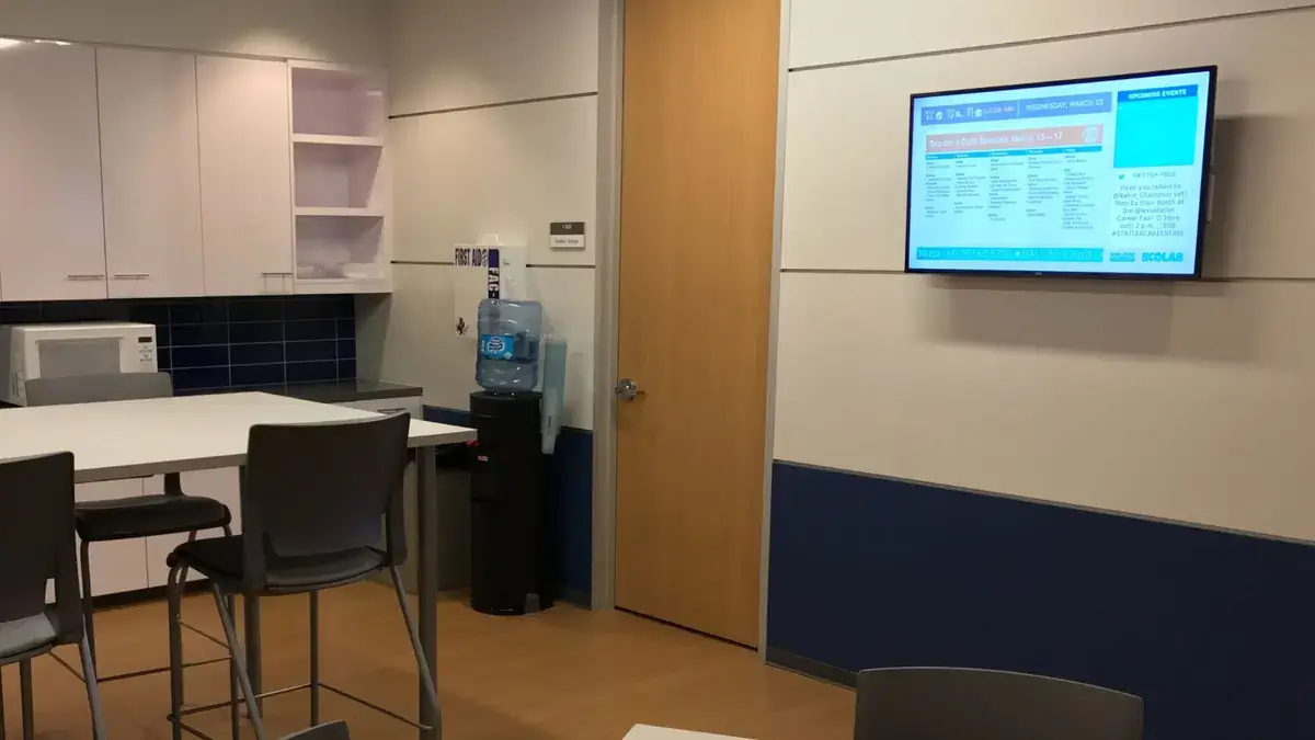 Ecolab break room digital signage software from Reach Media Network displaying monthly specials, upcoming events, and social media.