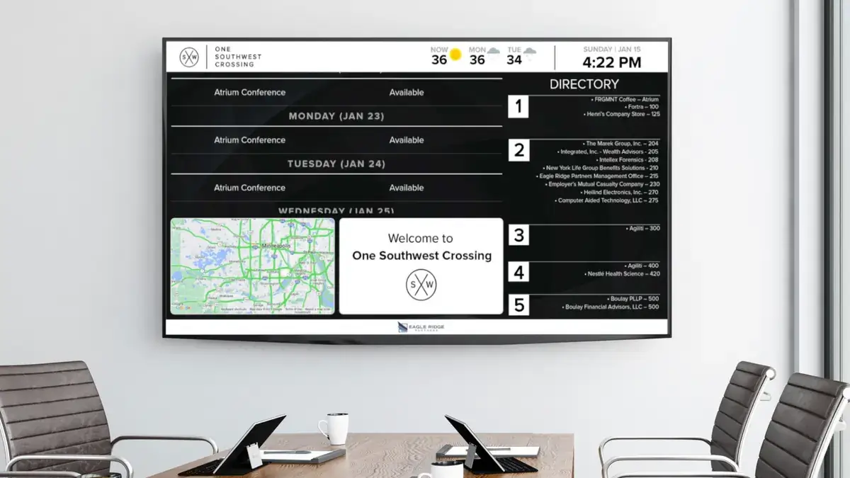 Corporate digital signage from Reach Media Network featured in One Southwest Crossing conference room, displaying room schedule, directory, local map, and welcome message.