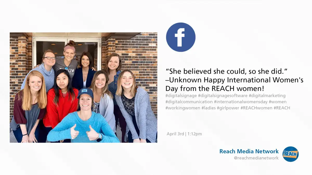 Digital signage screen displaying REACH Media Network Facebook social media post promoting women in the workplace for International Women's Day.