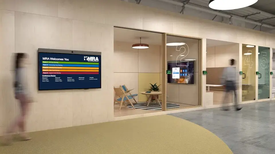 Corporate digital signage from Reach Media Network displaying various room schedules for MRA office.