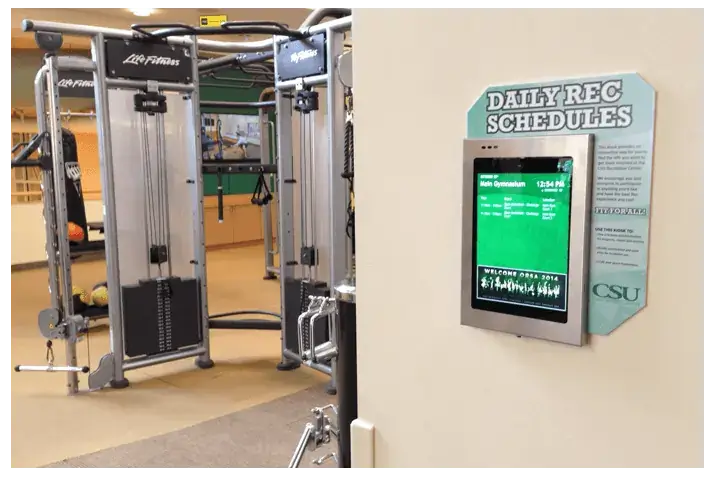 iPad digital signage screens from Reach Media Network displaying daily rec schedules for gym at CSU