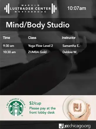 JCC Chicago Marvin Lustbader Center digital signage screen from Reach Media Network displaying mind/body studio class schedule and Starbucks special offers.