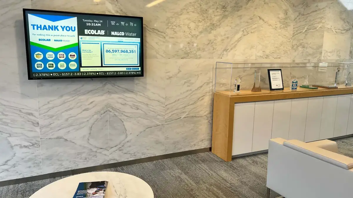 Ecolab corporate digital signage from Reach Media Network featured in lobby, displaying sponsor thank you message.